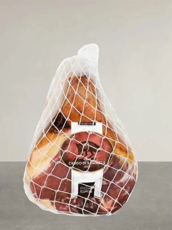Et stykke Gran Crudo di San Daniele DOP beinfri fra Edizione Franchi – en italiensk spekeskinke produsert i San Daniele del Friuli, modnet i minimum 13 måneder, med en balansert smak og delikat aroma, presentert i en elegant emballasje.